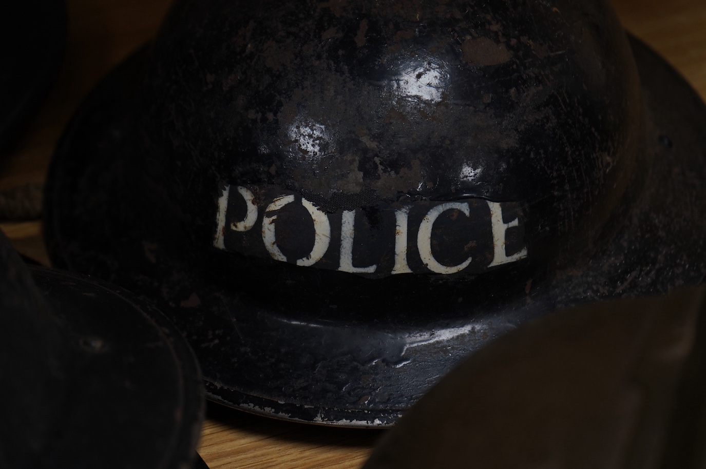 Seven early to mid 20th century military tin helmets; including one stencilled with POLICE. Condition - poor to fair.